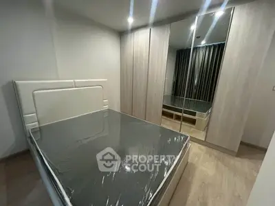 Modern bedroom with sleek mirrored wardrobe and minimalist design