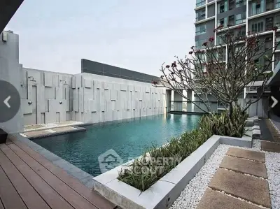 Luxurious modern apartment complex with serene outdoor pool and stylish landscaping.