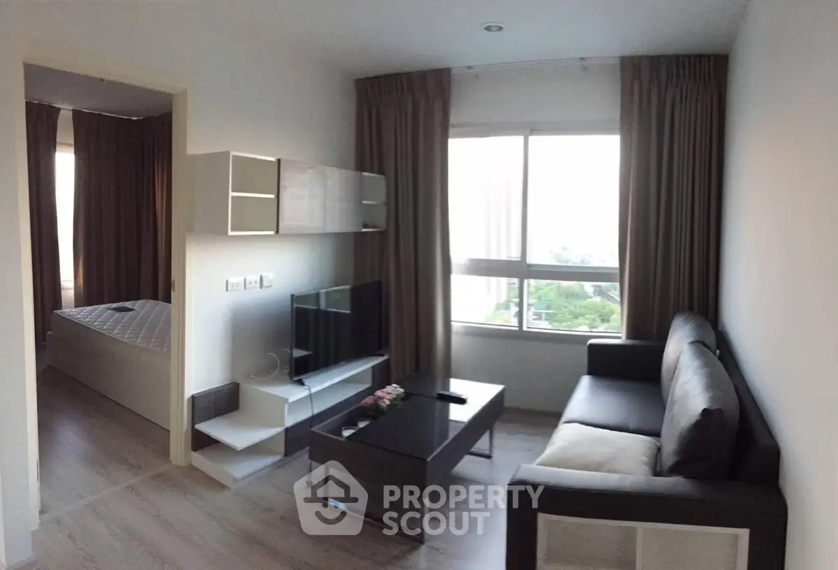 Modern living room with sleek furniture and large window view