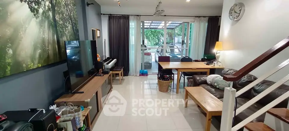 Spacious living room with modern decor and large windows for natural light.