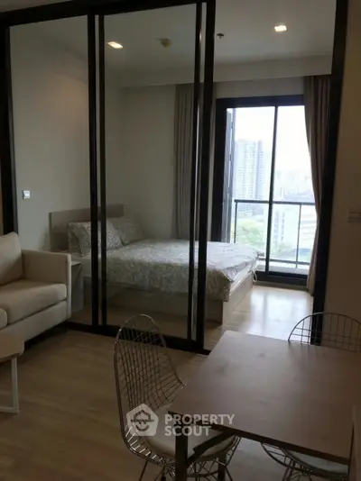 Modern apartment with glass partitioned bedroom and city view balcony