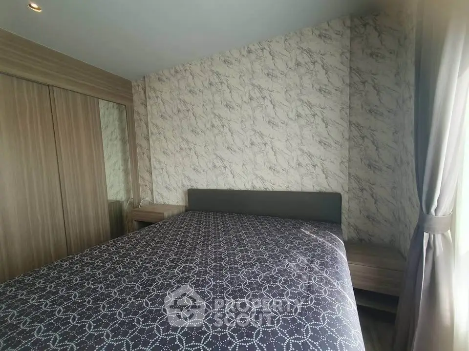 Cozy bedroom with modern design and natural light, featuring a comfortable bed and stylish decor.