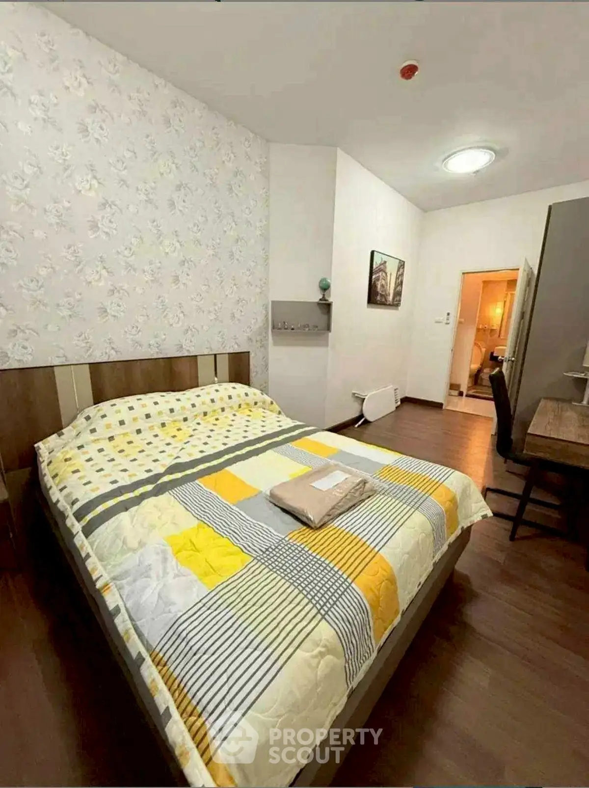 Cozy bedroom with modern decor and comfortable bed in a stylish apartment.