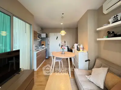 Charming open-plan living room with cozy seating and modern kitchen area.