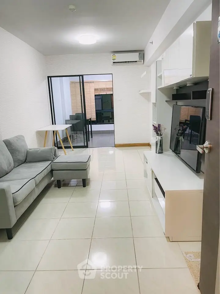 Modern living room with sleek furniture and open layout in a stylish apartment.
