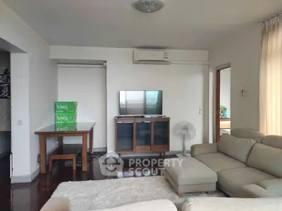 Spacious living room with modern furniture and natural light, perfect for relaxation and entertainment.