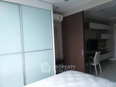 Modern bedroom with sliding closet doors and built-in desk area