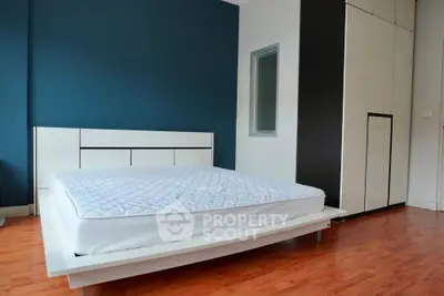 Modern minimalist bedroom with sleek design and wooden flooring