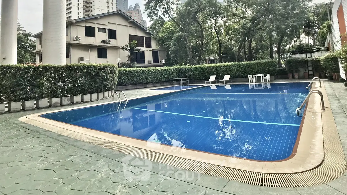 Luxurious outdoor pool area with lush greenery and modern design