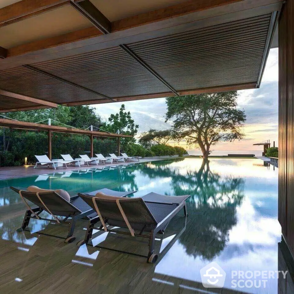 Luxurious poolside view with modern lounge chairs and serene landscape