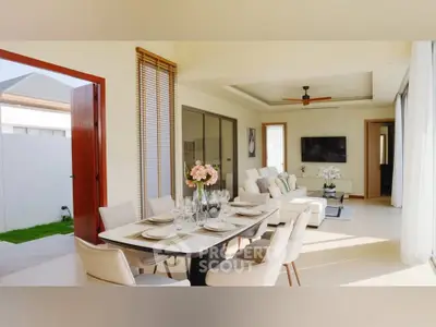 Luxurious open-plan living and dining area with elegant decor and abundant natural light.