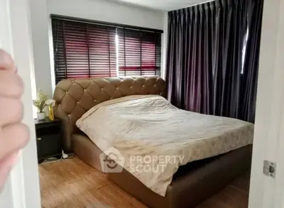 Cozy bedroom with elegant bed and stylish curtains in modern apartment.