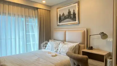 Luxurious bedroom with elegant decor and large window offering natural light