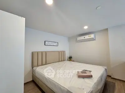 Modern bedroom with minimalist design and air conditioning unit
