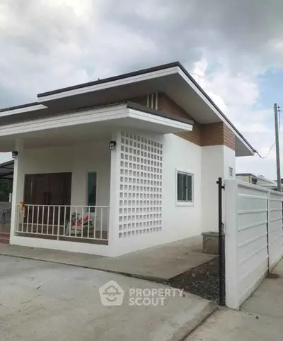 Modern single-story house with unique architectural design and spacious driveway.