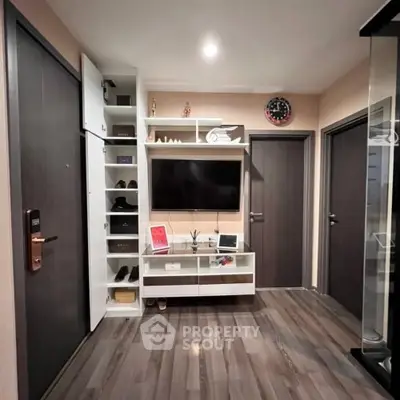 Modern living room with sleek storage and wall-mounted TV