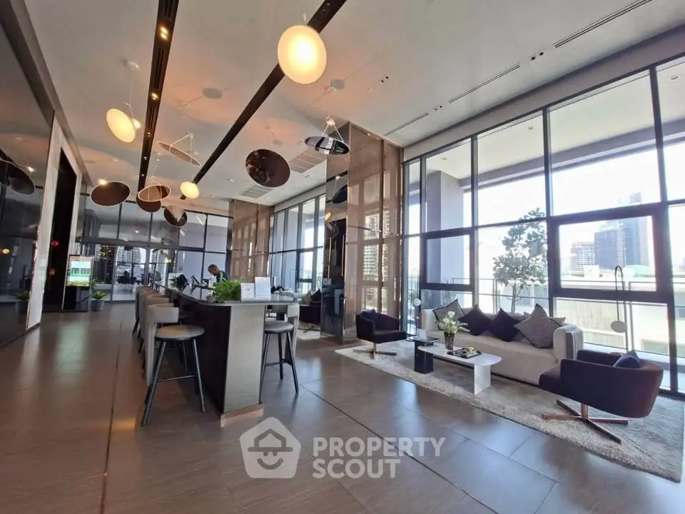 Spacious modern living room with floor-to-ceiling windows and stylish decor in a luxury apartment.