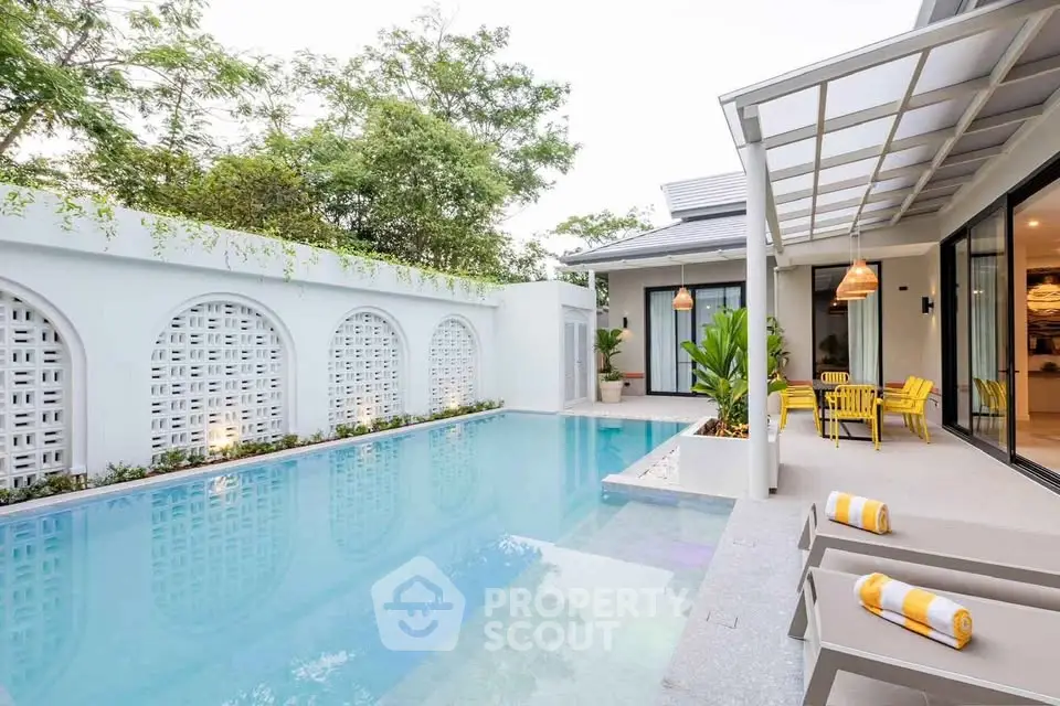 Luxurious modern villa with private pool and stylish outdoor seating area, perfect for relaxation and entertainment.