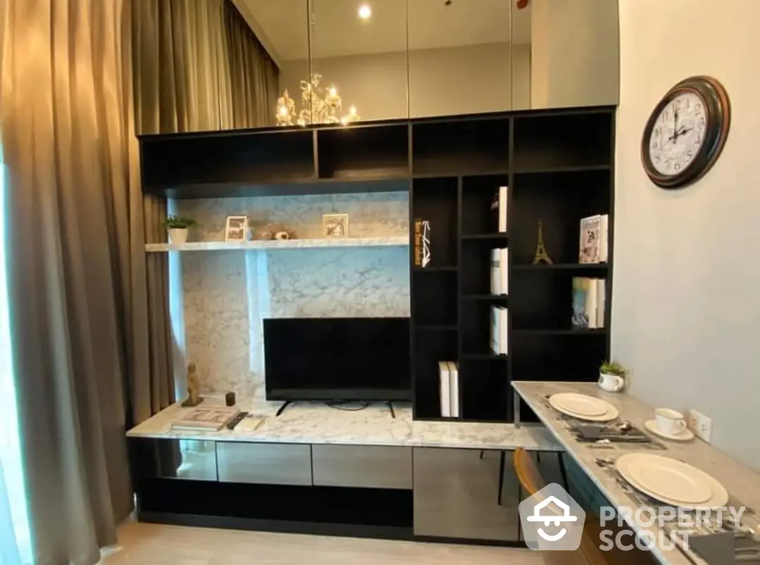 Elegantly designed living space with modern entertainment unit, marble accents, and chic dining setup, perfect for urban lifestyles.