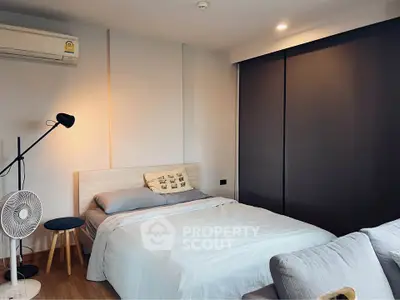 Cozy bedroom with modern decor and soft lighting, featuring a comfortable bed and stylish furnishings.