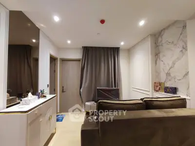 Modern living room with elegant marble accent wall and cozy seating area