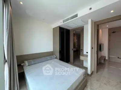 Modern bedroom with large windows and minimalist design in luxury apartment.
