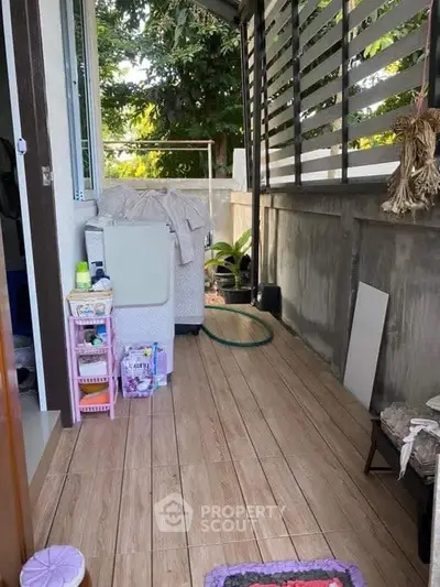 Charming small balcony with cozy seating and lush greenery, perfect for relaxation and outdoor enjoyment.