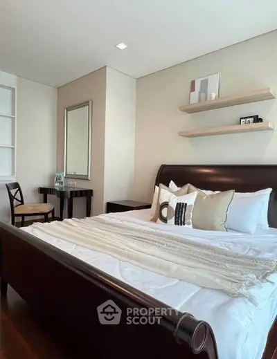 Luxurious bedroom with elegant decor and cozy bedding in modern apartment.