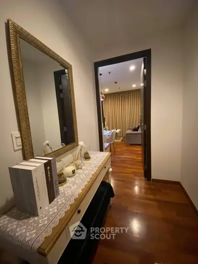 Elegant hallway leading to a cozy living room with warm lighting and stylish decor.