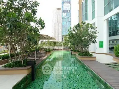 Luxurious apartment complex with stunning outdoor pool and lush greenery.