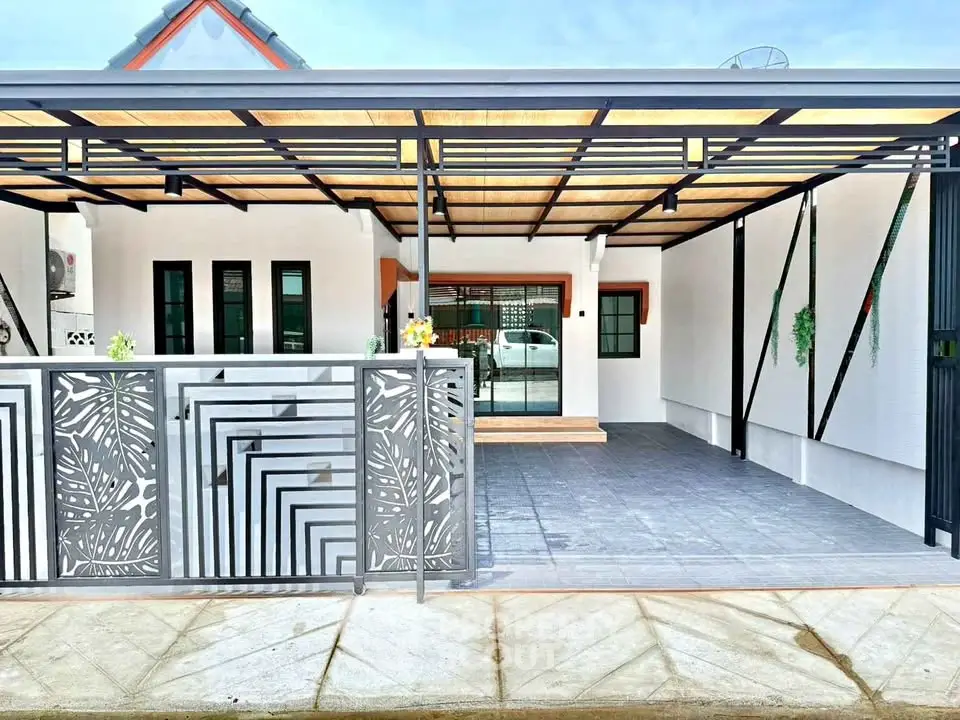 Modern house exterior with stylish metal gate and covered patio area.