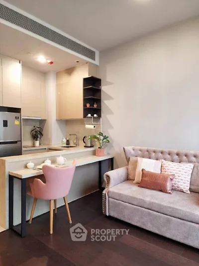 Chic studio apartment with a seamless open layout, featuring a modern kitchen with high-end appliances, and a cozy living area with stylish furnishings.