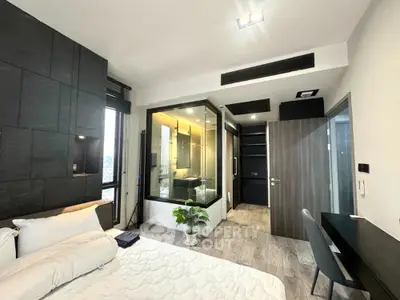 Modern bedroom with glass-enclosed bathroom and sleek design