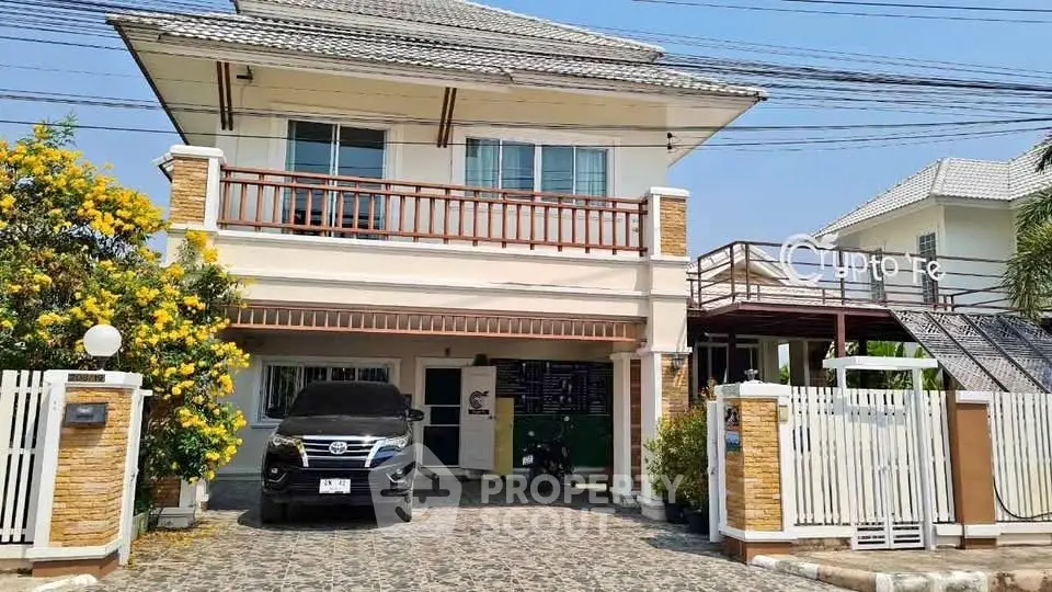 Charming two-story house with spacious driveway and lush garden, perfect for family living.