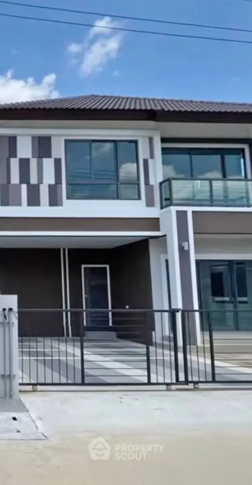 Modern two-story house with stylish facade and gated entrance