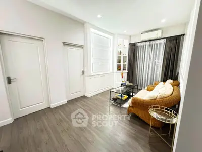 Charming living room with elegant decor and cozy seating area, perfect for relaxation and entertaining.