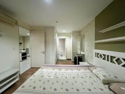 Cozy bedroom with modern decor and ensuite bathroom in a stylish apartment.