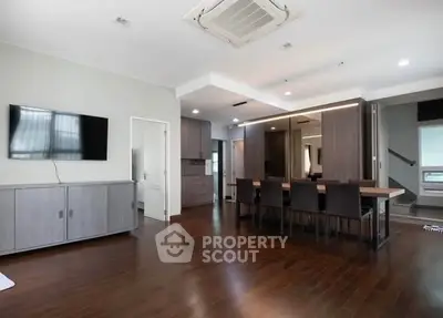 Spacious modern living room with dining area and sleek wooden flooring