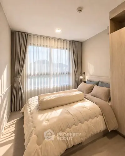 Cozy bedroom with large window and elegant curtains, featuring a plush bed and soft lighting.