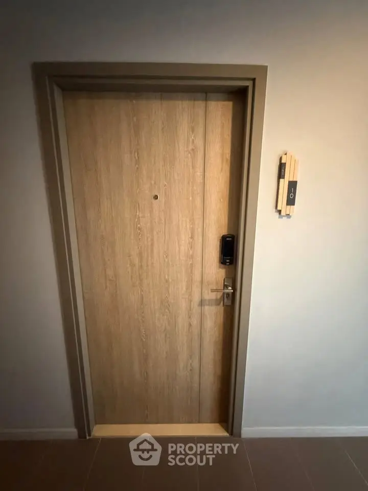Modern apartment entrance with secure electronic lock and intercom system.