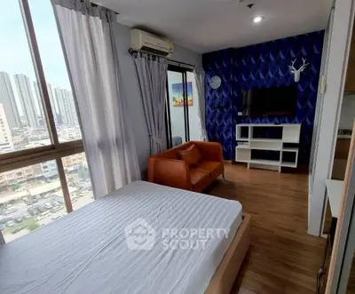 Modern bedroom with city view, stylish decor, and cozy seating area.