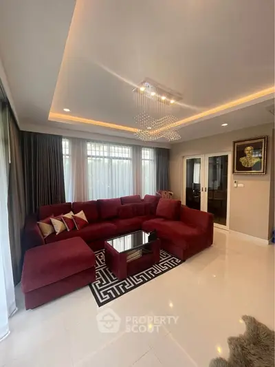 Luxurious living room with plush red sectional sofa and elegant lighting