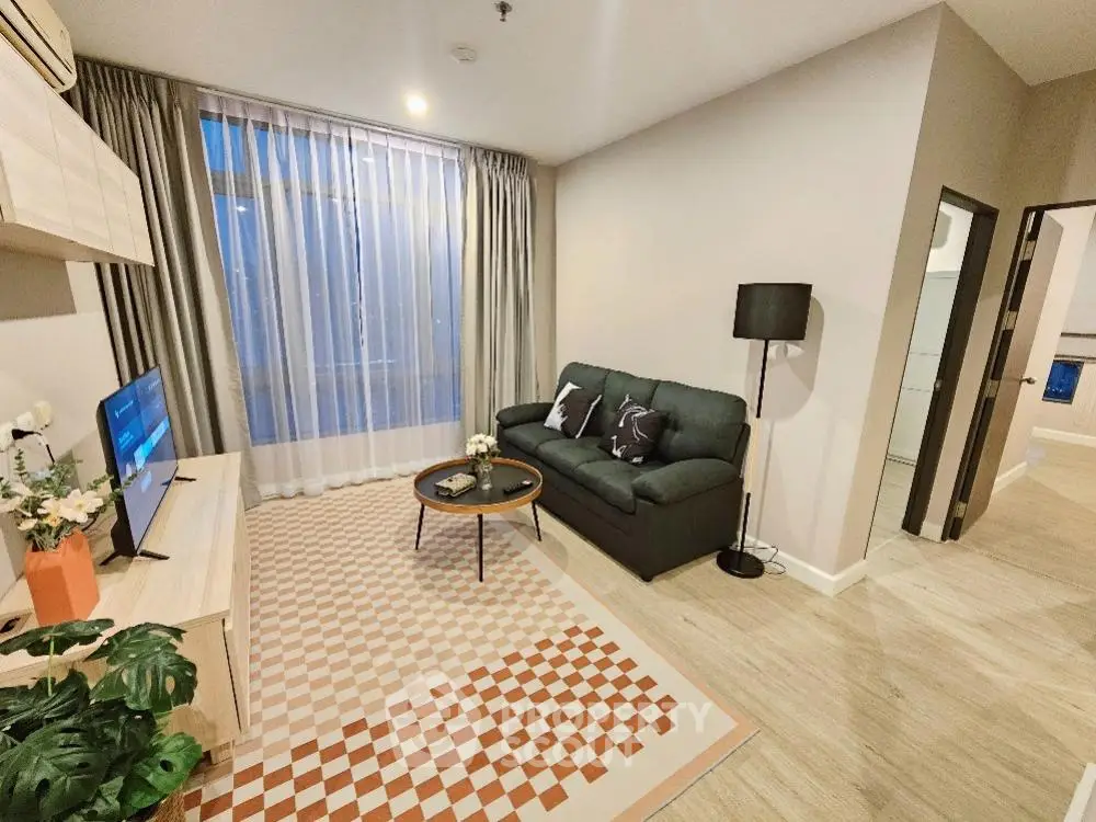 Modern living room with cozy sofa, stylish decor, and natural light.