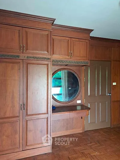 Elegant wooden wardrobe with built-in mirror in a cozy bedroom setting