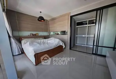 Modern bedroom with sleek design and ample storage space