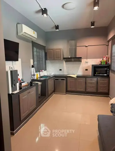 Modern kitchen with sleek cabinetry, stainless steel appliances, and ample counter space in a stylish home.