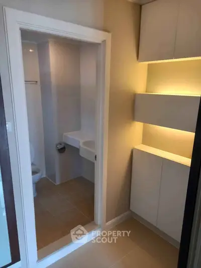 Modern bathroom with sleek design and built-in storage cabinets
