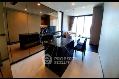 Luxurious modern living room with elegant marble island and floor-to-ceiling windows.
