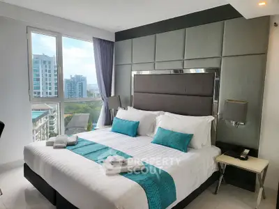 Luxurious bedroom with modern decor and stunning city view in high-rise apartment.