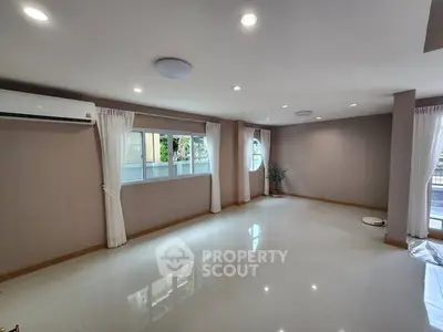 Spacious modern living room with large windows and sleek flooring